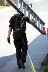 4 Signs Your Chimney Needs Cleaning - Conifer CO - Chimney Doctors chimney sweep carrying a ladder